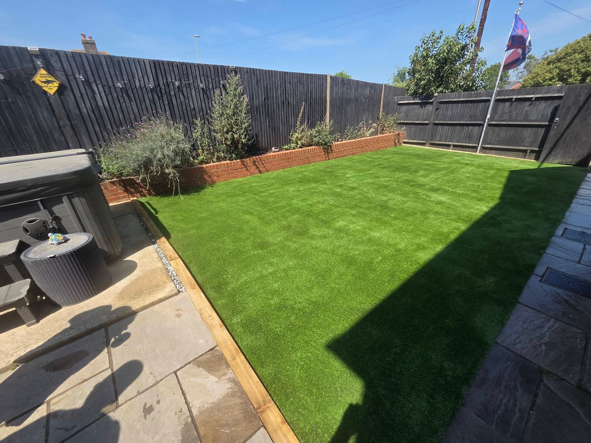 Artificial grass with clean edge detailing by WJB Construction